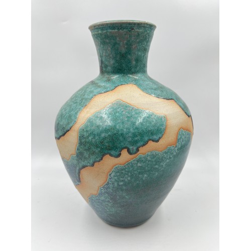 311 - A studio pottery vase with impressed 'P' to base - approx. 27cm high