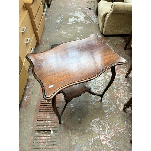17 - An Edwardian mahogany serpentine two tier side table