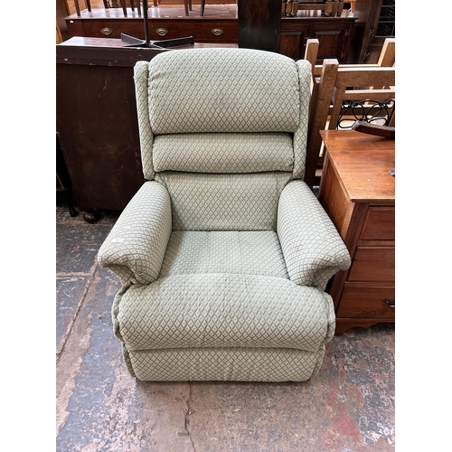 26 - A green fabric reclining armchair