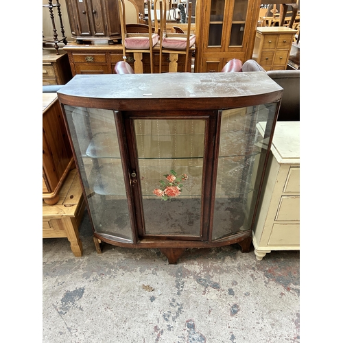 27 - A mid 20th century stained pine display cabinet with single door and two internal glass shelves