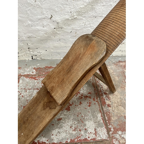 29 - A carved teak folding plank chair - approx. 144cm when folded