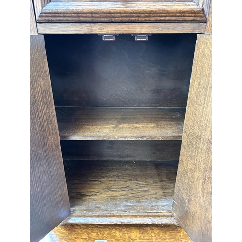 68 - An oak side cabinet with two cupboard doors and single drawer