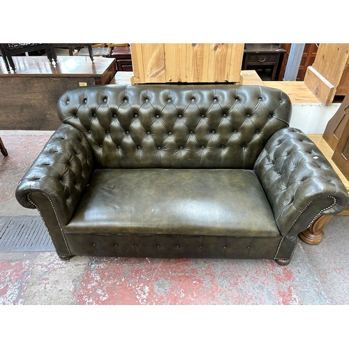 152 - A 1930s green leather Chesterfield drop arm sofa
