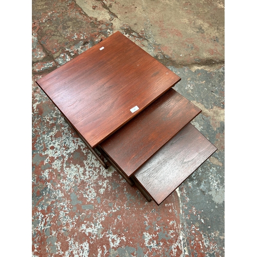 161 - A stained teak nest of three tables