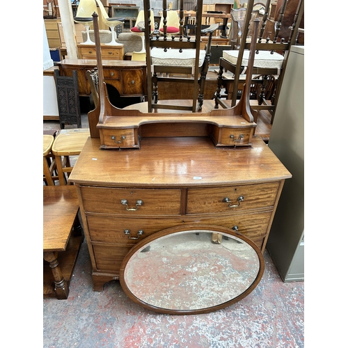 209 - An Edwardian mahogany dressing chest with upper oval bevelled edge mirror, two short drawers and two... 