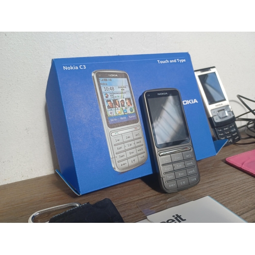 695 - Four items, one boxed Nokia C3 mobile phone with charger, one Nokia Slide 6500S mobile phone with ch... 