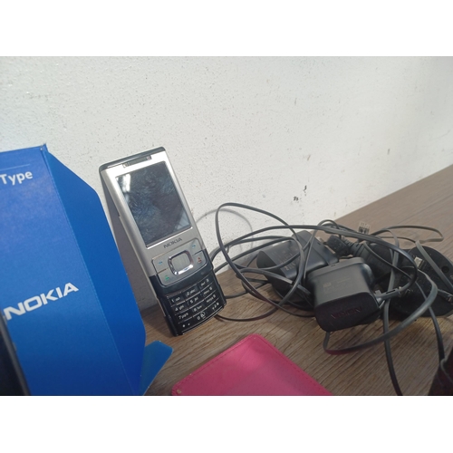 695 - Four items, one boxed Nokia C3 mobile phone with charger, one Nokia Slide 6500S mobile phone with ch... 