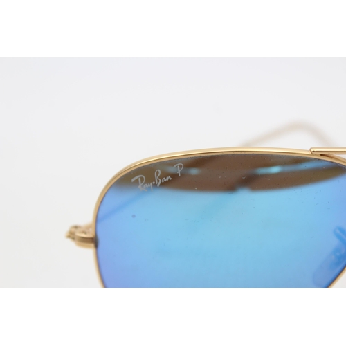 556 - A pair of cased Ray-Ban Aviator sunglasses with polarized lenses