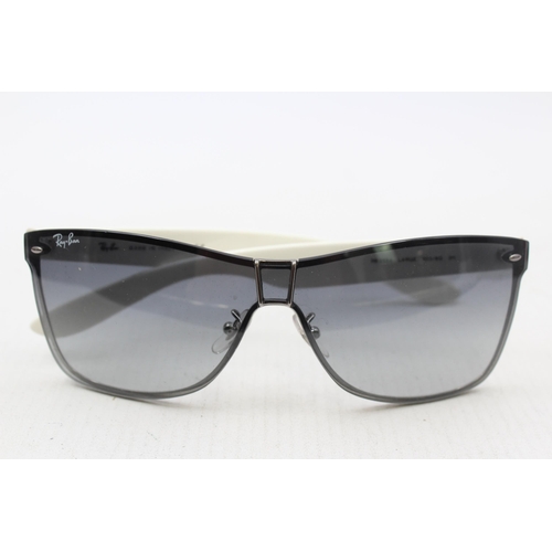 558 - A pair of cased Ray-Ban Y2K style frameless sunglasses