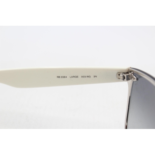 558 - A pair of cased Ray-Ban Y2K style frameless sunglasses