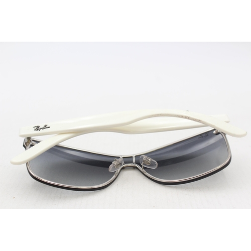 558 - A pair of cased Ray-Ban Y2K style frameless sunglasses