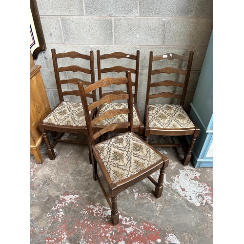10 - A set of four beech and tapestry upholstered ladder back dining chairs
