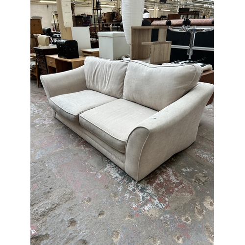 107 - A modern fabric upholstered three seater sofa