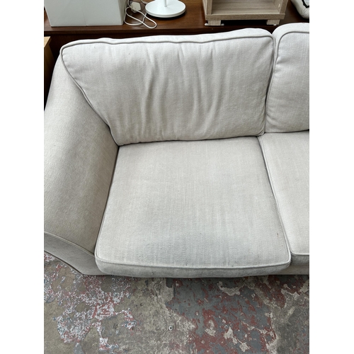 107 - A modern fabric upholstered three seater sofa