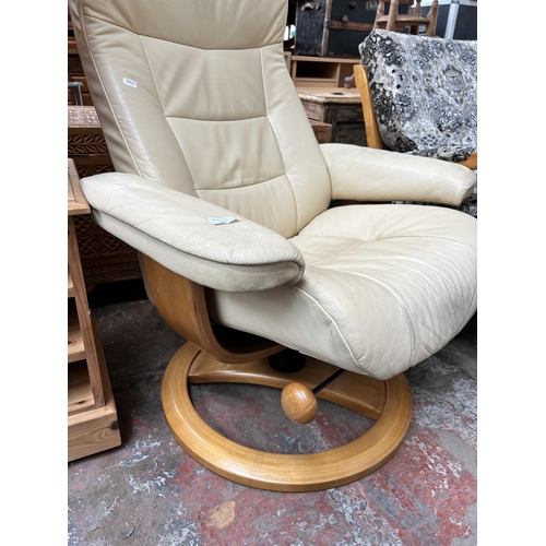 111 - A Stressless style cream leather and bentwood swivel reclining armchair and footstool