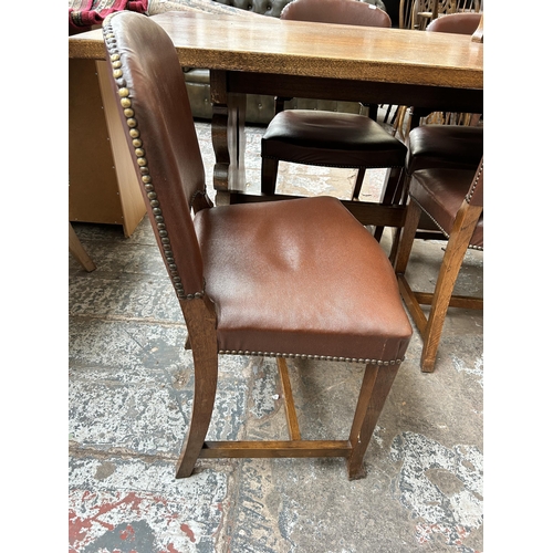 115 - An oak rectangular trestle dining table and five brown leatherette dining chairs