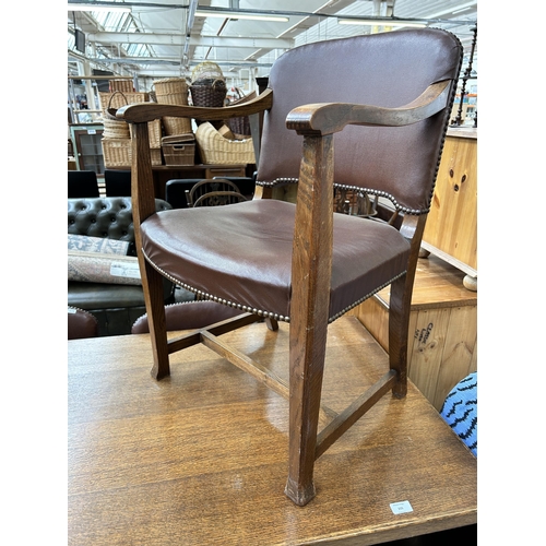 115 - An oak rectangular trestle dining table and five brown leatherette dining chairs