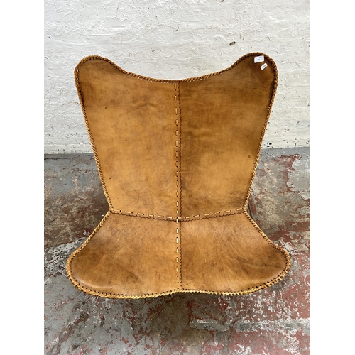 121 - A brown leather butterfly chair