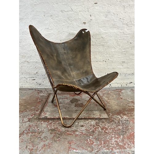 122 - A brown leather butterfly chair