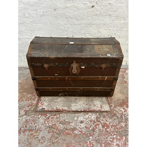 123 - An early 20th century oak banded fibreboard travel trunk