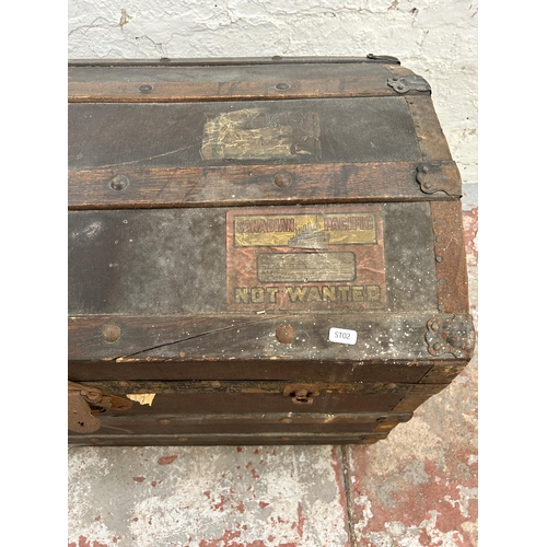 123 - An early 20th century oak banded fibreboard travel trunk