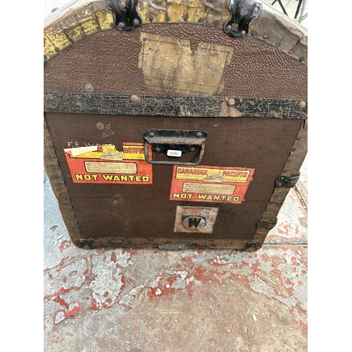 123 - An early 20th century oak banded fibreboard travel trunk