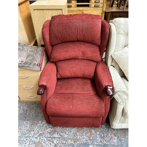 128 - A red fabric upholstered reclining armchair