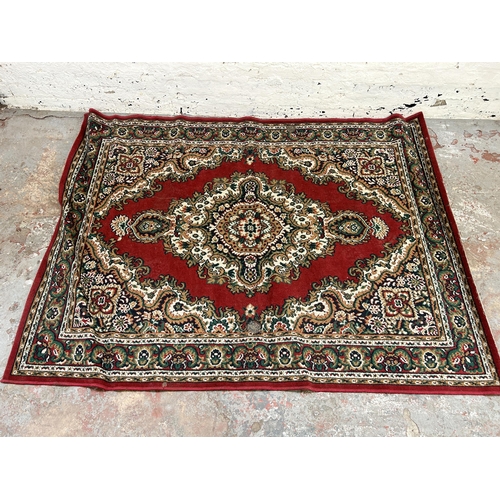 129 - A Belgian red rug - approx. 220cm x 160cm