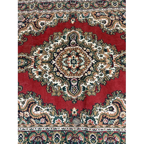 129 - A Belgian red rug - approx. 220cm x 160cm