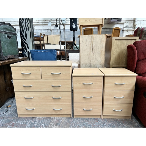 130 - Three pieces of beech effect bedroom furniture, two bedside chests of three drawers and one chest of... 