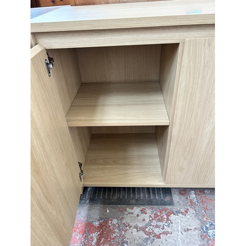 146 - An oak effect sideboard with two cupboard doors