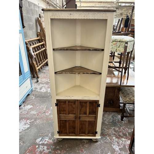 15 - An oak and white painted free standing corner cabinet