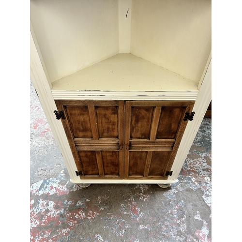 15 - An oak and white painted free standing corner cabinet