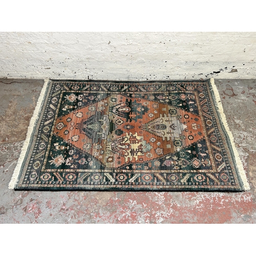 153 - A Persian style blue rug - approx. 180cm x 120cm