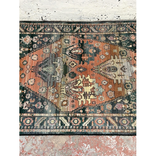 153 - A Persian style blue rug - approx. 180cm x 120cm