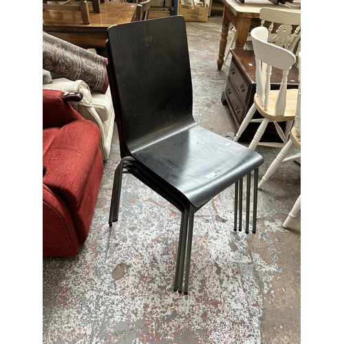 156 - Four black painted and grey metal stacking dining chairs