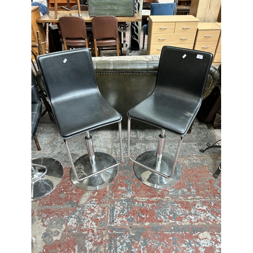 168 - A pair of black leatherette and chrome plated kitchen barstools