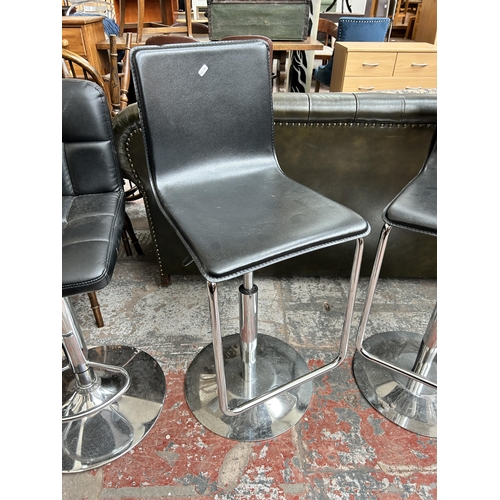 168 - A pair of black leatherette and chrome plated kitchen barstools