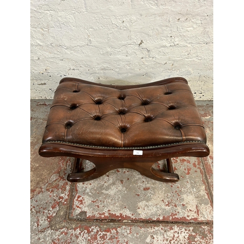 173 - A brown leather and mahogany Chesterfield footstool