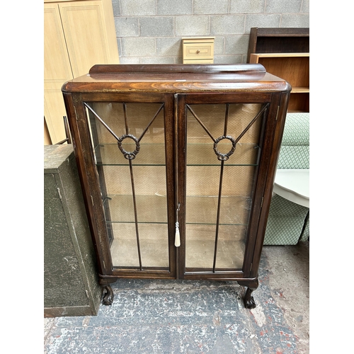 37 - An early 20th century mahogany display cabinet with two glazed doors, two glass shelves and ball and... 