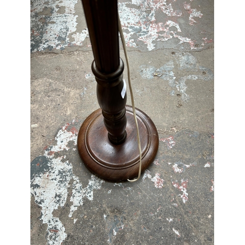 45 - A mahogany standard lamp with circular base - approx. 133cm high