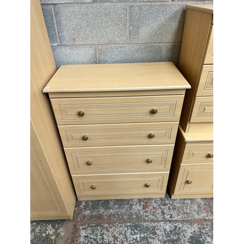 5 - A beech effect six piece bedroom suite comprising chest of five drawers, bedside chest of three draw... 