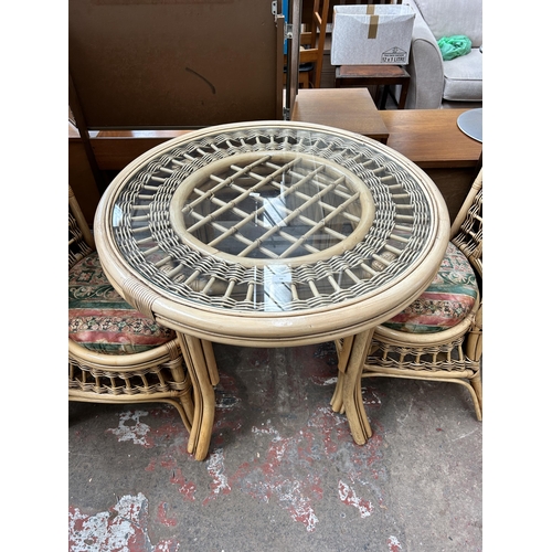 53 - A bamboo and wicker three piece dining set comprising circular table and two chairs
