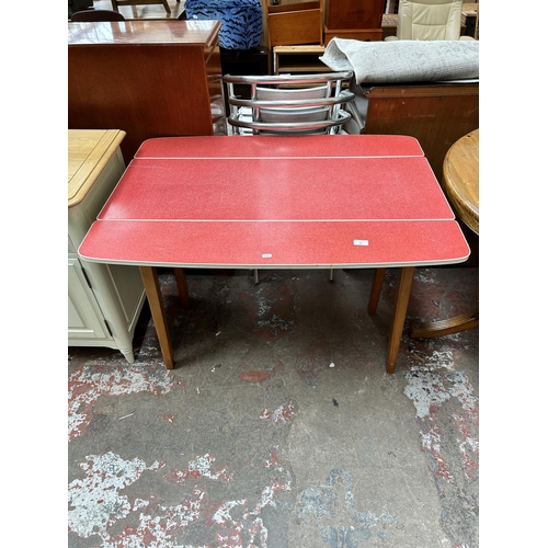 58 - A mid 20th century red formica and beech drop leaf kitchen table
