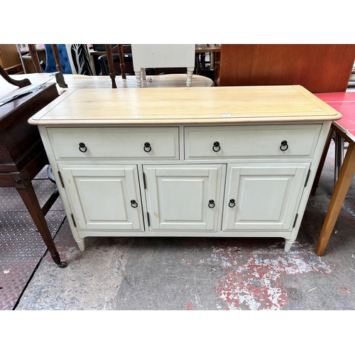 60 - A modern oak and white painted sideboard with two drawers and three cupboard doors