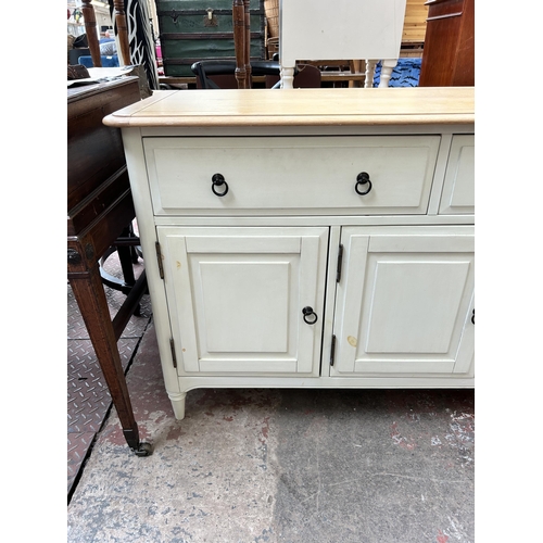 60 - A modern oak and white painted sideboard with two drawers and three cupboard doors