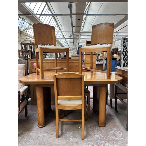 64 - An Art Deco oak and walnut dining table and four matching chairs