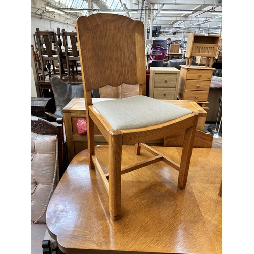 64 - An Art Deco oak and walnut dining table and four matching chairs