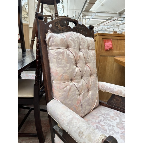 65 - An Edwardian carved oak and fabric upholstered armchair