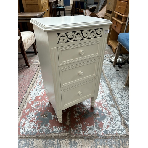 76 - A French style white painted bedside chest of three drawers